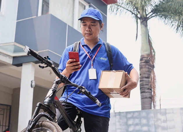Odda Courier on Bicycle with Parcel